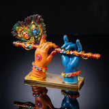 A divine idol of Radha-Krishna holding a flute