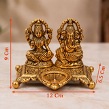 Golden Aluminium Lakshmi-Ganesha Idol with a Diya